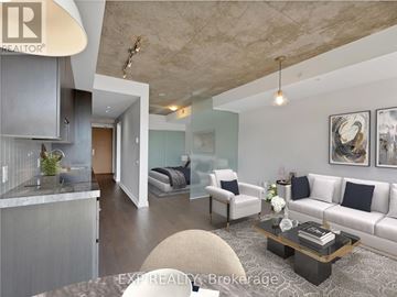 Toronto (Waterfront Communities) condo for rent - A modern living room with a grey sofa and a glass coffee table.