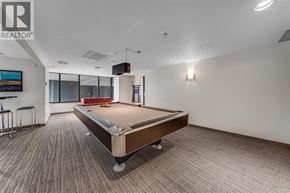 Vancouver apartment for rent - A pool table in a room with a Realtor logo on the wall.
