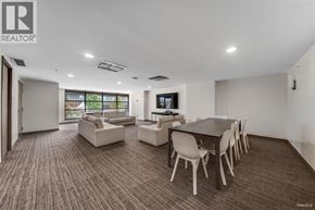 Vancouver apartment for rent - A living room with a brown carpet and white furniture.