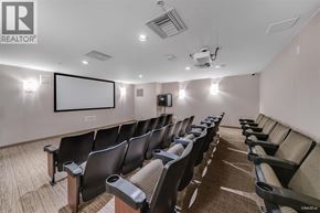 Vancouver apartment for rent - A row of black chairs are arranged in a room with a white screen at the front.