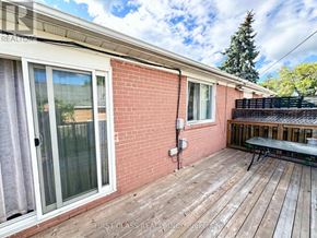 Richmond Hill (Crosby) apartment for rent - A red brick house with a wooden deck and a glass door.