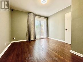 Richmond Hill (Crosby) apartment for rent - A room with wooden flooring and a window with curtains.