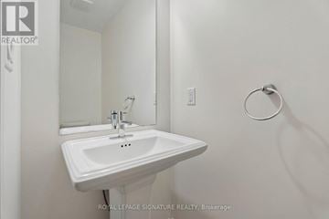 Hamilton (Stoney Creek Mountain) townhouse for rent - A white sink in a bathroom with a mirror above it.