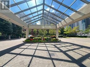 Toronto (Willowdale East) condo for rent - A glass pavilion with a garden in the middle of a paved area.