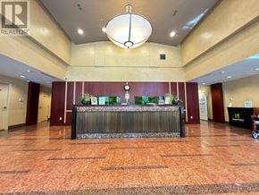 Toronto (Willowdale East) condo for rent - A reception area with a counter and a clock on the wall.