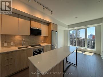 Toronto (Regent Park) condo for rent - A kitchen with wooden cabinets and a white countertop.