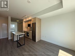 Toronto (Regent Park) condo for rent - A modern kitchen with a table and chairs in a spacious room.
