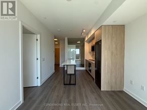 Toronto (Regent Park) condo for rent - A modern kitchen with a wooden floor and white walls.