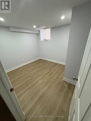 Brampton (Bram East) apartment for rent - A room with wooden flooring and white walls.