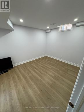 Brampton (Bram East) apartment for rent - A room with wooden flooring and white walls, with a window on the right side.