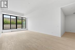 Toronto (Thorncliffe Park) condo for rent - A spacious room with a large window and wooden flooring.