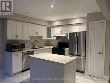 Burlington (Tansley) townhouse for rent - A kitchen with white cabinets and a white island.