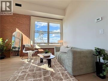 Hamilton apartment for rent - A living room with a couch, chair, and a table with a plant on it.