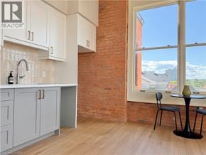Hamilton apartment for rent - A kitchen with a large window overlooking a residential area.