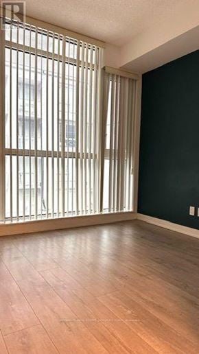 Toronto (Waterfront Communities) condo for rent - A room with a window covered by vertical blinds.