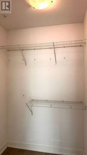 Toronto (Waterfront Communities) condo for rent - A white closet with two shelves and a light on.