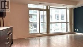 Toronto (Waterfront Communities) condo for rent - A room with a stove and a large window overlooking a city.