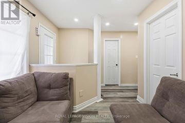 Oshawa (Samac) apartment for rent - A living room with a couch and a door.