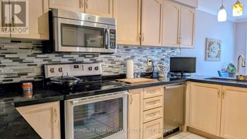 Vaughan (Sonoma Heights) apartment for rent - A kitchen with a stove top oven and microwave above it.