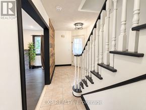 Brampton (Brampton North) townhouse for rent - A hallway with a black railing and white walls.