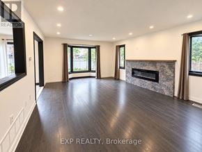 Brampton (Brampton North) townhouse for rent - A spacious living room with wood flooring and a fireplace.