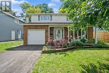 Ottawa apartment for rent - A house with a garage and a driveway.