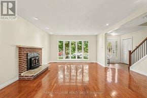 Ottawa apartment for rent - A spacious living room with a fireplace and hardwood floors.