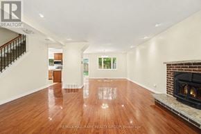 Ottawa apartment for rent - A spacious living room with a fireplace and hardwood floors.