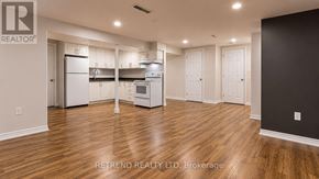 Toronto (Tam O'shanter-Sullivan) apartment for rent - A kitchen with white appliances and wooden floors.