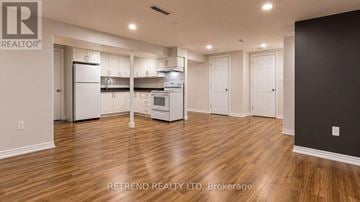 Toronto (Tam O'shanter-Sullivan) apartment for rent - A kitchen with white appliances and wooden floors.