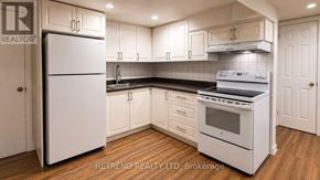 Toronto (Tam O'shanter-Sullivan) apartment for rent - A kitchen with white appliances and cabinets.