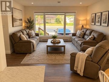 St. John's multi-family for rent - A living room with brown couches and a coffee table.