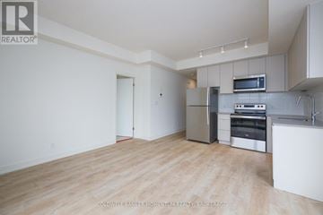 St. Catharines (E. Chester) townhouse for rent - A spacious kitchen with white cabinets and stainless steel appliances.