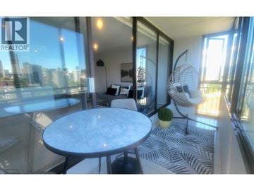 Vancouver apartment for rent - A living room with a marble table and a zebra print rug.