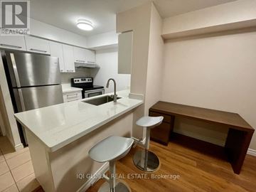 Toronto (Lansing-Westgate) condo for rent - A kitchen with white cabinets and a stainless steel refrigerator.