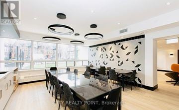 Toronto (University) condo for rent - A modern dining room with a large table and chairs.