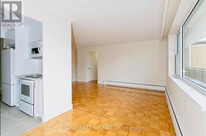 Toronto (Thorncliffe Park) condo for rent - A kitchen with white appliances and a wooden floor.