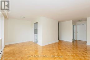 Toronto (Thorncliffe Park) condo for rent - A large empty room with wooden floors and white walls.