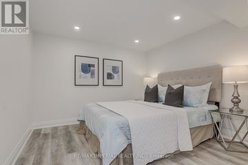 Newmarket (Huron Heights-Leslie Valley) apartment for rent - A bedroom with a large bed and two framed pictures on the wall.
