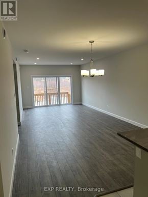 The Nation apartment for rent - A large, empty room with a balcony and a chandelier.