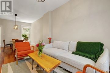 Ottawa townhouse for rent - A living room with a white couch and a wooden coffee table.