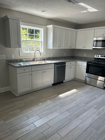 Shelbyville apartment for rent - A kitchen with white cabinets and a black stove top oven.