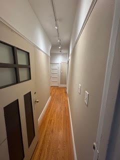 San Francisco apartment for rent - A long hallway with wood floors and white walls.