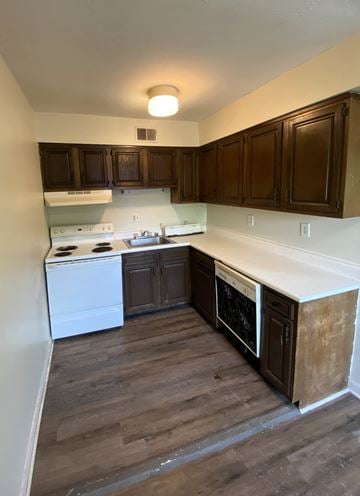 Louisville apartment for rent - A kitchen with wooden cabinets and a white stove top oven.