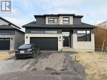 Russell apartment for rent - A modern house with a black car parked in front.