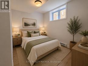 Russell apartment for rent - A bedroom with a bed, nightstands, and a plant.