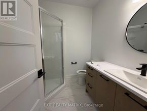Russell apartment for rent - A bathroom with a sink, mirror, and toilet.