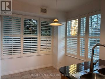 Toronto (Edenbridge-Humber Valley) condo for rent - A kitchen with a sink and a window with white shutters.