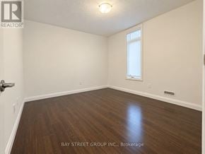 London South (South W) townhouse for rent - A room with wooden flooring and a window is for sale by Bay Street Group Inc.
