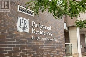 Oshawa (O'neill) condo for rent - A sign on a brick wall that says "Parkwood Residences 44-50 Bond Street West".